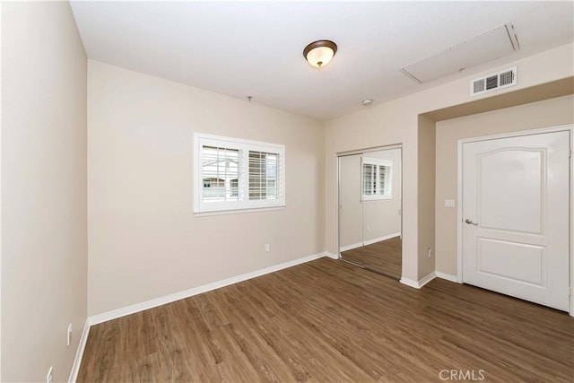 unfurnished room with dark wood-type flooring