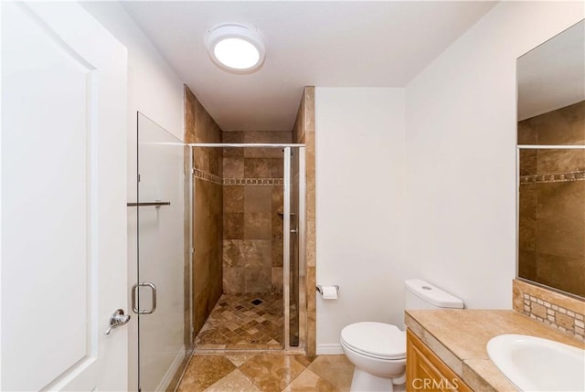 bathroom featuring vanity, an enclosed shower, and toilet