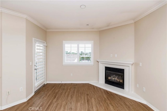 unfurnished living room with crown molding and hardwood / wood-style floors