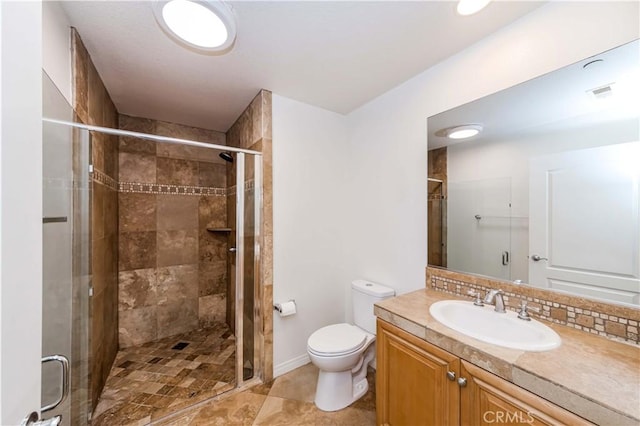 bathroom with walk in shower, tile patterned floors, vanity, and toilet