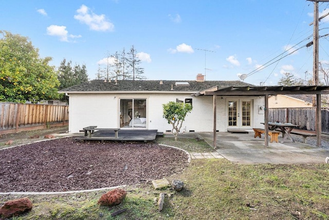 rear view of property featuring a patio, french doors, and a deck