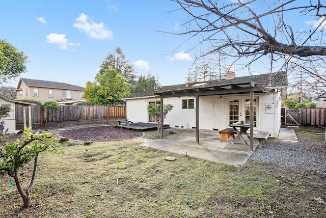 back of house with a lawn, a patio, and french doors