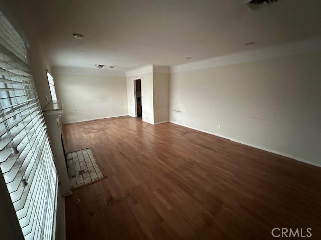 unfurnished room with dark wood-type flooring