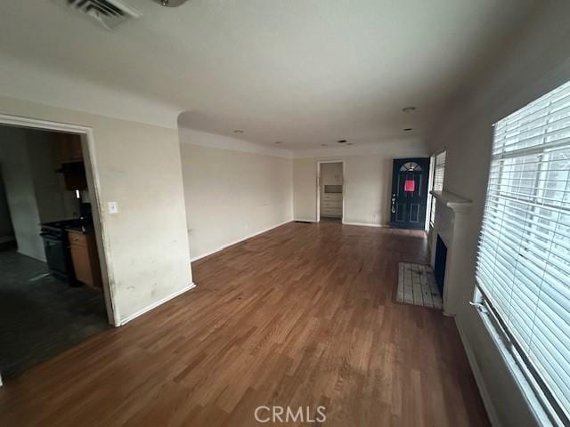 unfurnished living room with dark wood-type flooring