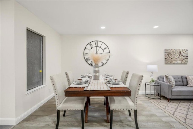 dining space featuring wood-type flooring