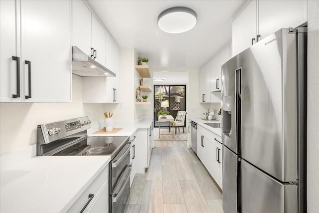 kitchen with stainless steel appliances, sink, and white cabinets