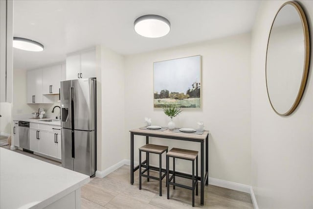 kitchen featuring sink, white cabinets, and appliances with stainless steel finishes