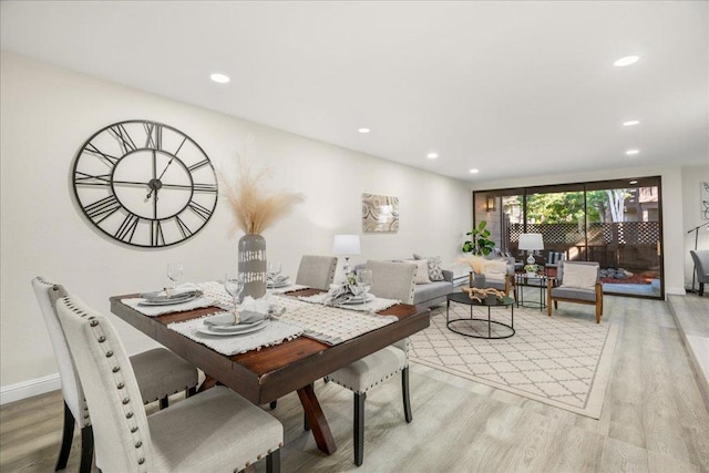 dining space with light hardwood / wood-style flooring