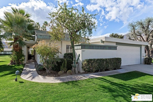 view of front of house with a garage and a front yard