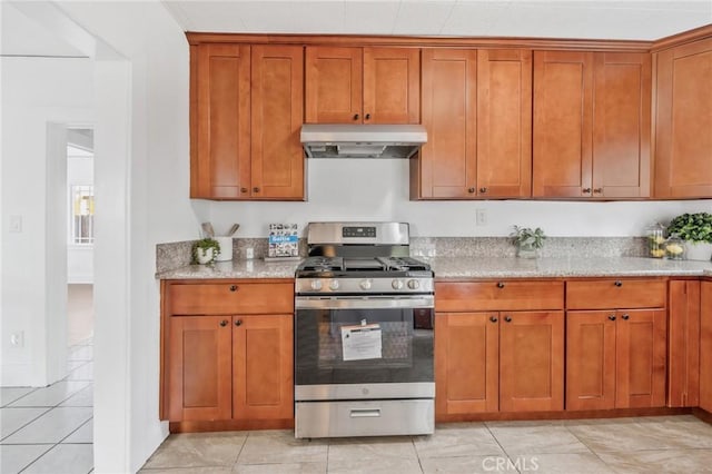 kitchen featuring light stone counters and stainless steel range with gas cooktop