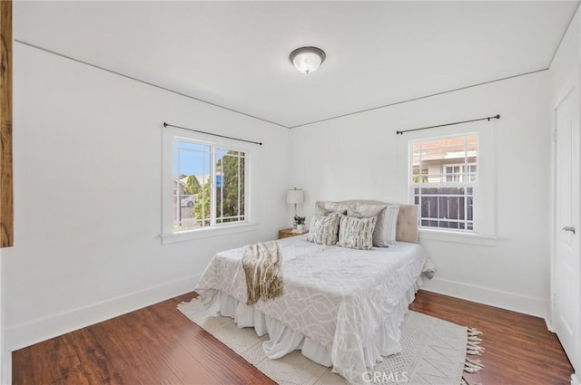 bedroom featuring multiple windows and hardwood / wood-style flooring