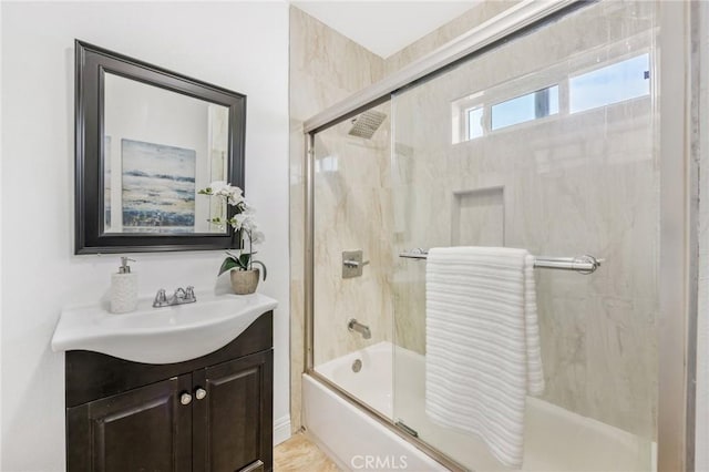 bathroom featuring vanity and combined bath / shower with glass door