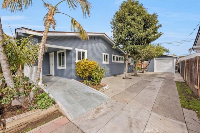 single story home with a garage and an outbuilding