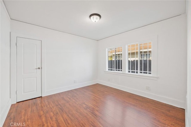 empty room with hardwood / wood-style flooring