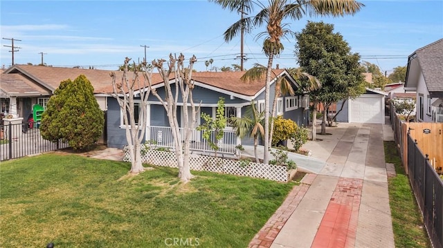 bungalow featuring a garage, an outdoor structure, a front yard, and covered porch