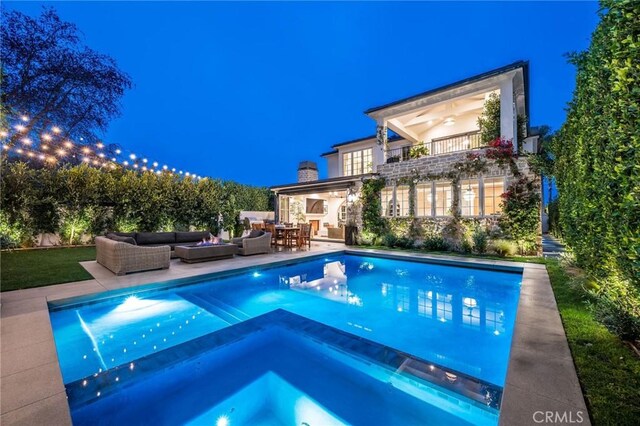 view of pool with an in ground hot tub, outdoor lounge area, and a patio