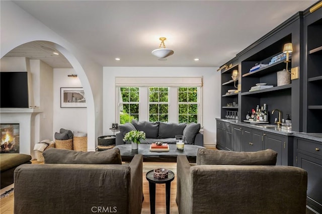 living room featuring hardwood / wood-style flooring and wet bar