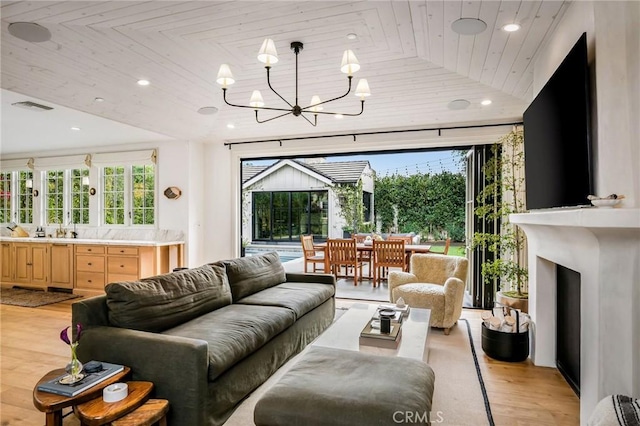 living room with light wood-type flooring, a wealth of natural light, wood ceiling, and a chandelier