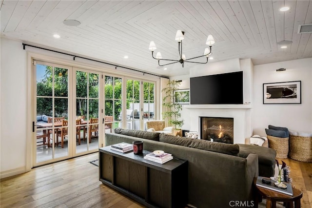 living room featuring french doors, a chandelier, light hardwood / wood-style floors, and wooden ceiling