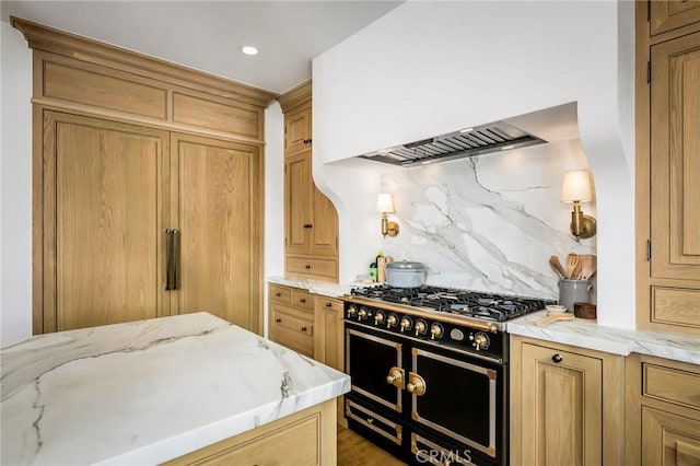 kitchen with tasteful backsplash, double oven range, light stone counters, and custom exhaust hood