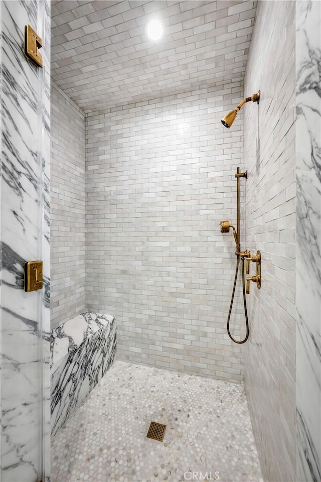 bathroom with a tile shower