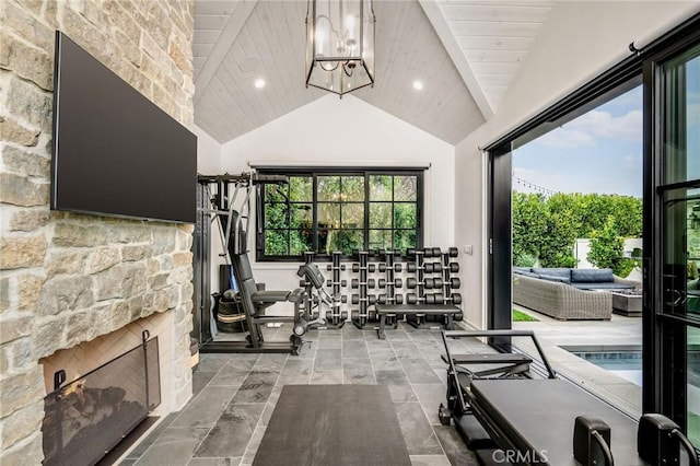 exercise room featuring a fireplace, wood ceiling, and vaulted ceiling