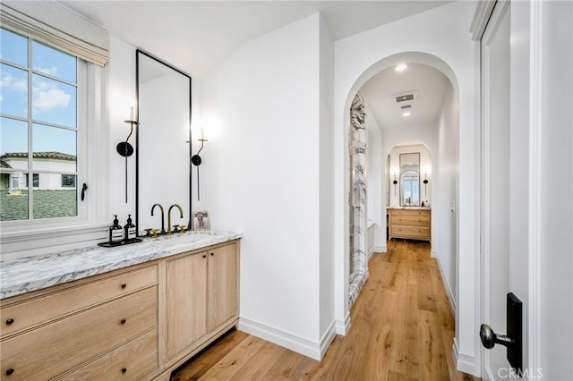 interior space with vanity and wood-type flooring