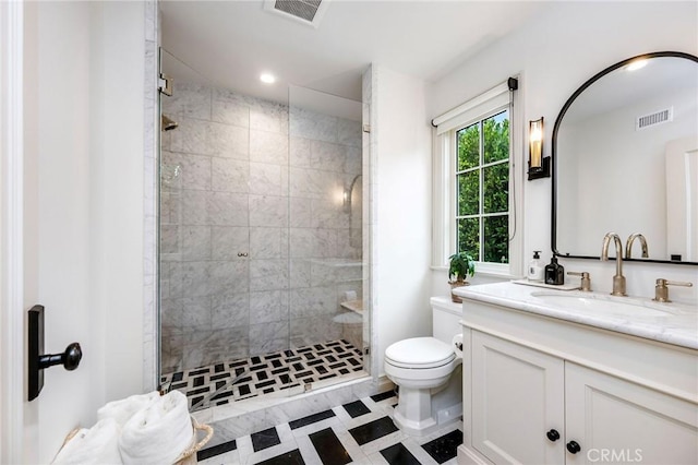 bathroom featuring vanity, toilet, and an enclosed shower