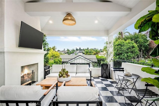 view of patio with an outdoor living space with a fireplace