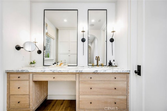 bathroom with hardwood / wood-style flooring and vanity