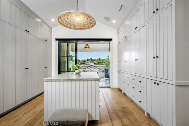 interior space with lofted ceiling and light hardwood / wood-style floors