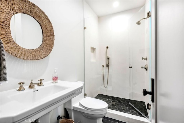 bathroom featuring toilet, sink, and a shower