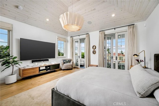 bedroom with vaulted ceiling, hardwood / wood-style floors, access to outside, wooden ceiling, and french doors