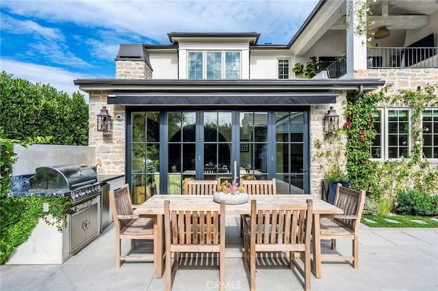 rear view of house with a patio and area for grilling