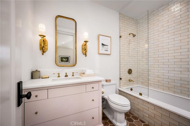 full bathroom with vanity, tiled shower / bath combo, tile patterned floors, and toilet