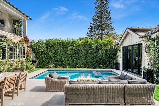 view of pool featuring an outdoor living space and a patio