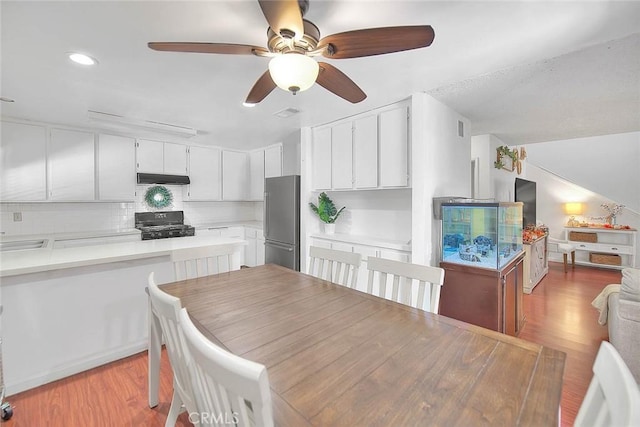 dining space featuring sink and light hardwood / wood-style floors