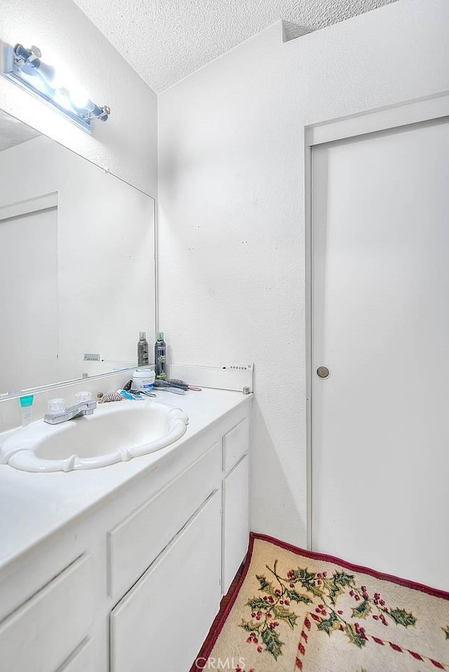 bathroom featuring vanity and a textured ceiling