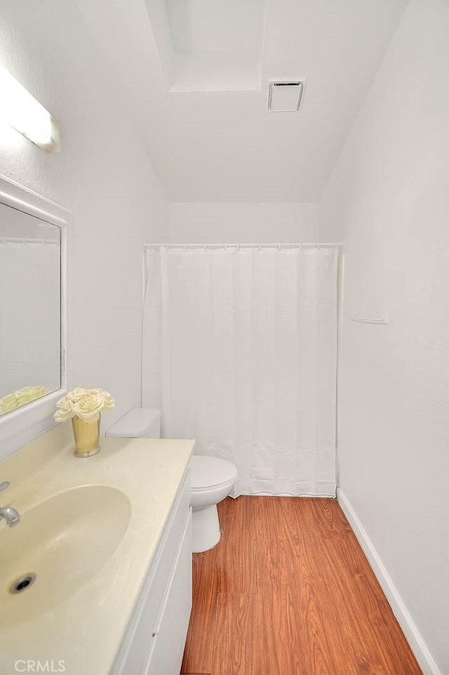 bathroom featuring hardwood / wood-style flooring, vanity, and toilet