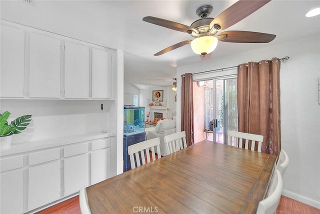 dining area with ceiling fan and light hardwood / wood-style flooring