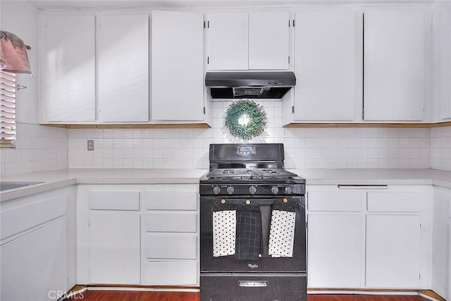 kitchen with tasteful backsplash, black range with gas stovetop, ventilation hood, and white cabinets