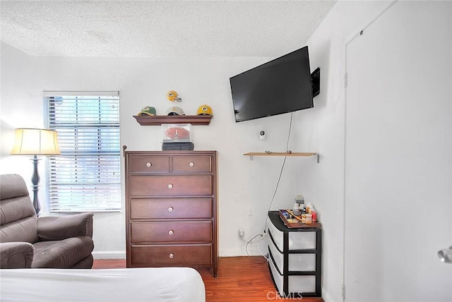 interior space featuring light hardwood / wood-style flooring and a textured ceiling