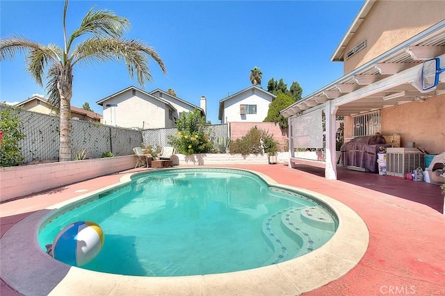 view of swimming pool featuring area for grilling and a patio area