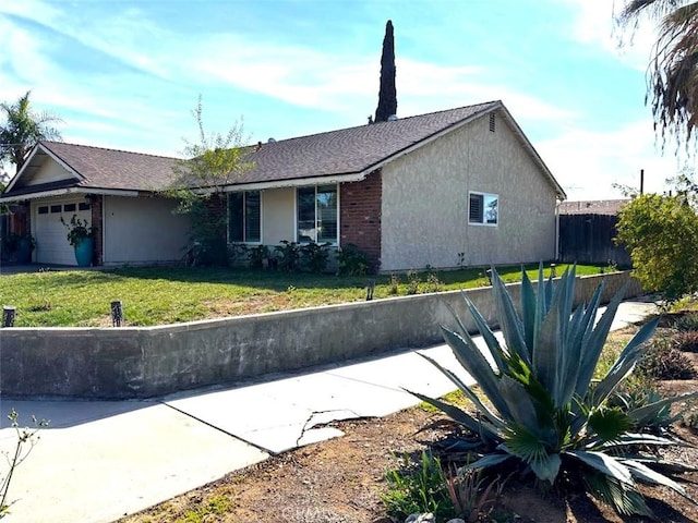 view of side of home with a garage and a yard