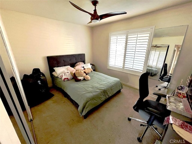 bedroom featuring ceiling fan and carpet