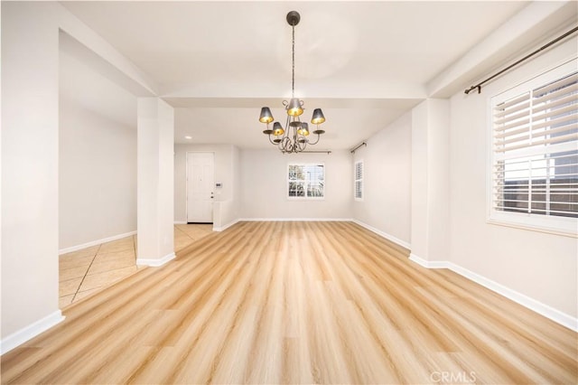 interior space featuring an inviting chandelier and light hardwood / wood-style floors