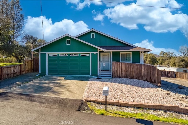 ranch-style house with a garage, fence, a porch, and concrete driveway