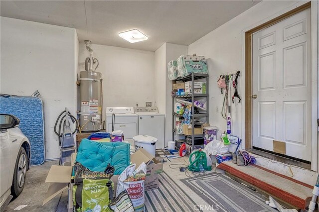 misc room with secured water heater, concrete floors, and independent washer and dryer