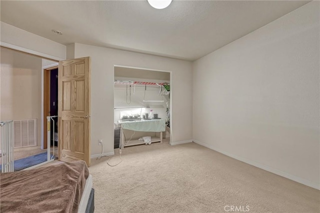 unfurnished bedroom featuring carpet floors, baseboards, and visible vents