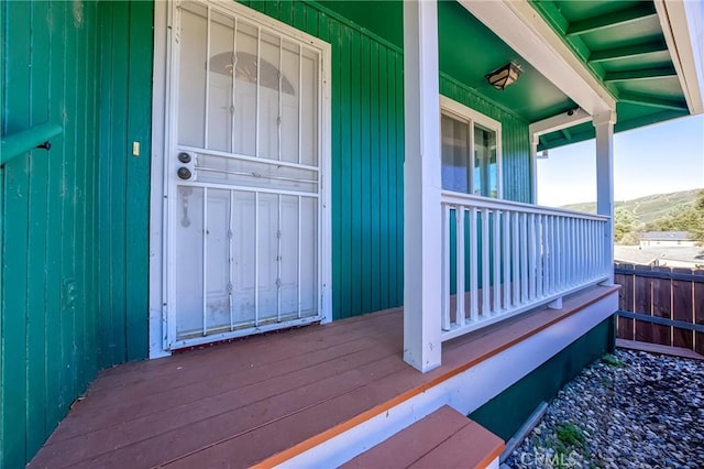 doorway to property featuring covered porch and a mountain view